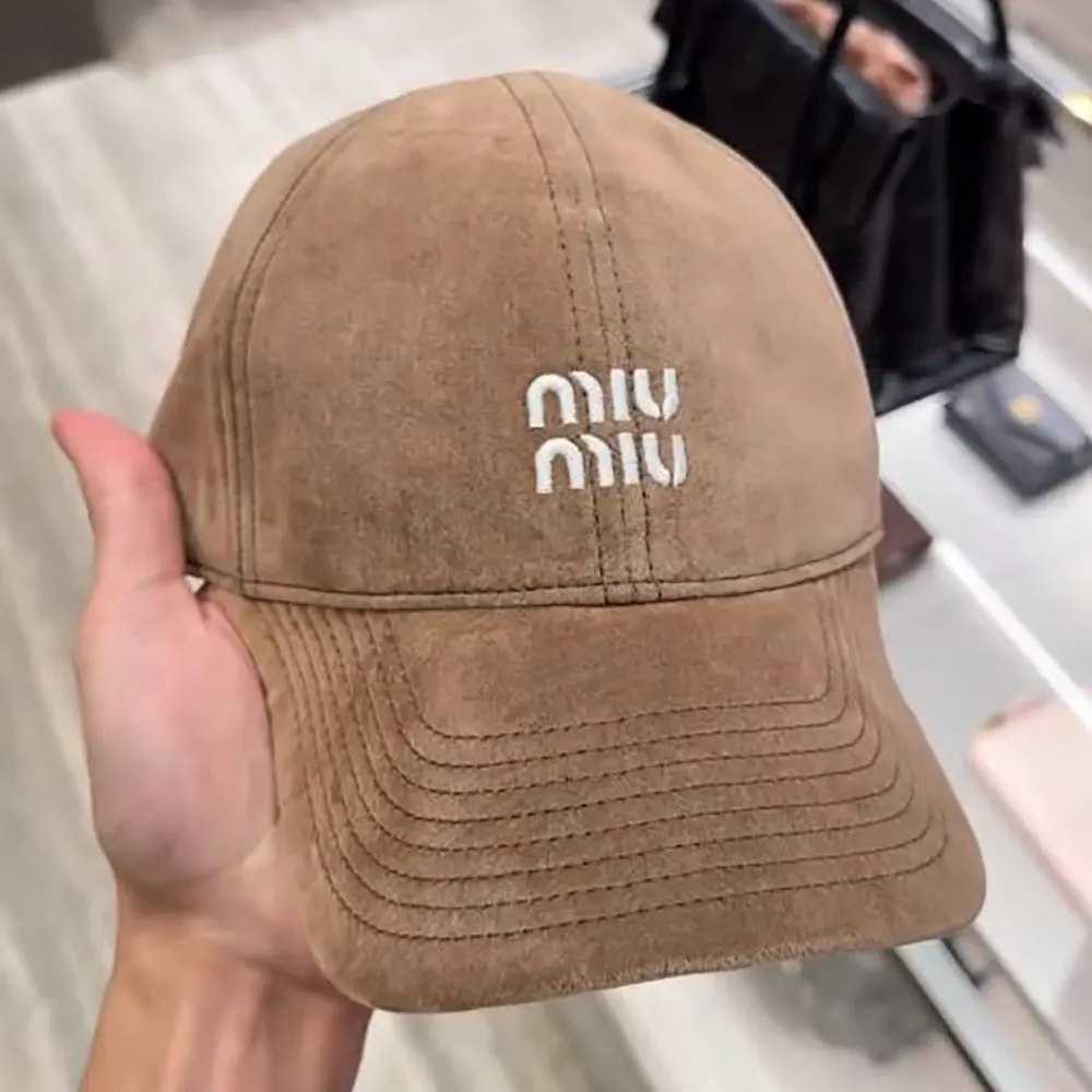 Close-up of Miu Miu metal logo on Velvet Baseball Cap-Sand/Black