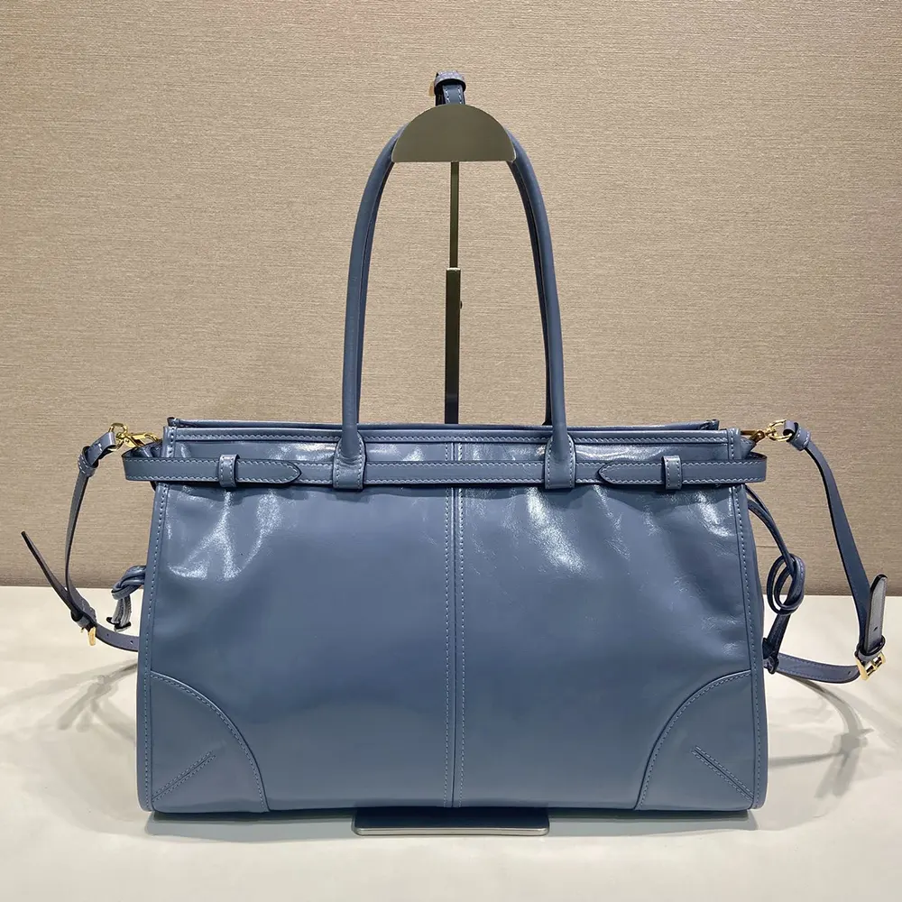Side angle showing strap and flap closure of Prada Bonnie bag