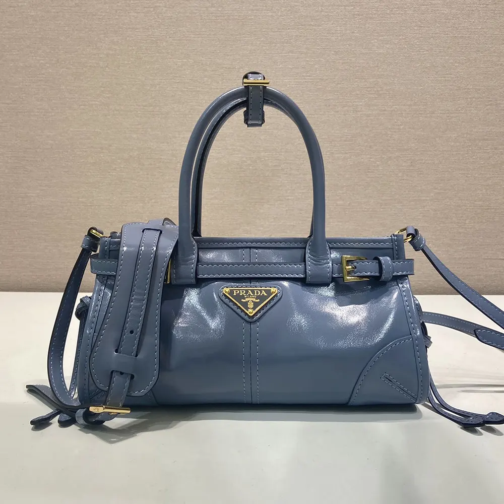 Side angle showing slim silhouette of Prada Women Bonnie Leather Mini Handbag-Light Blue