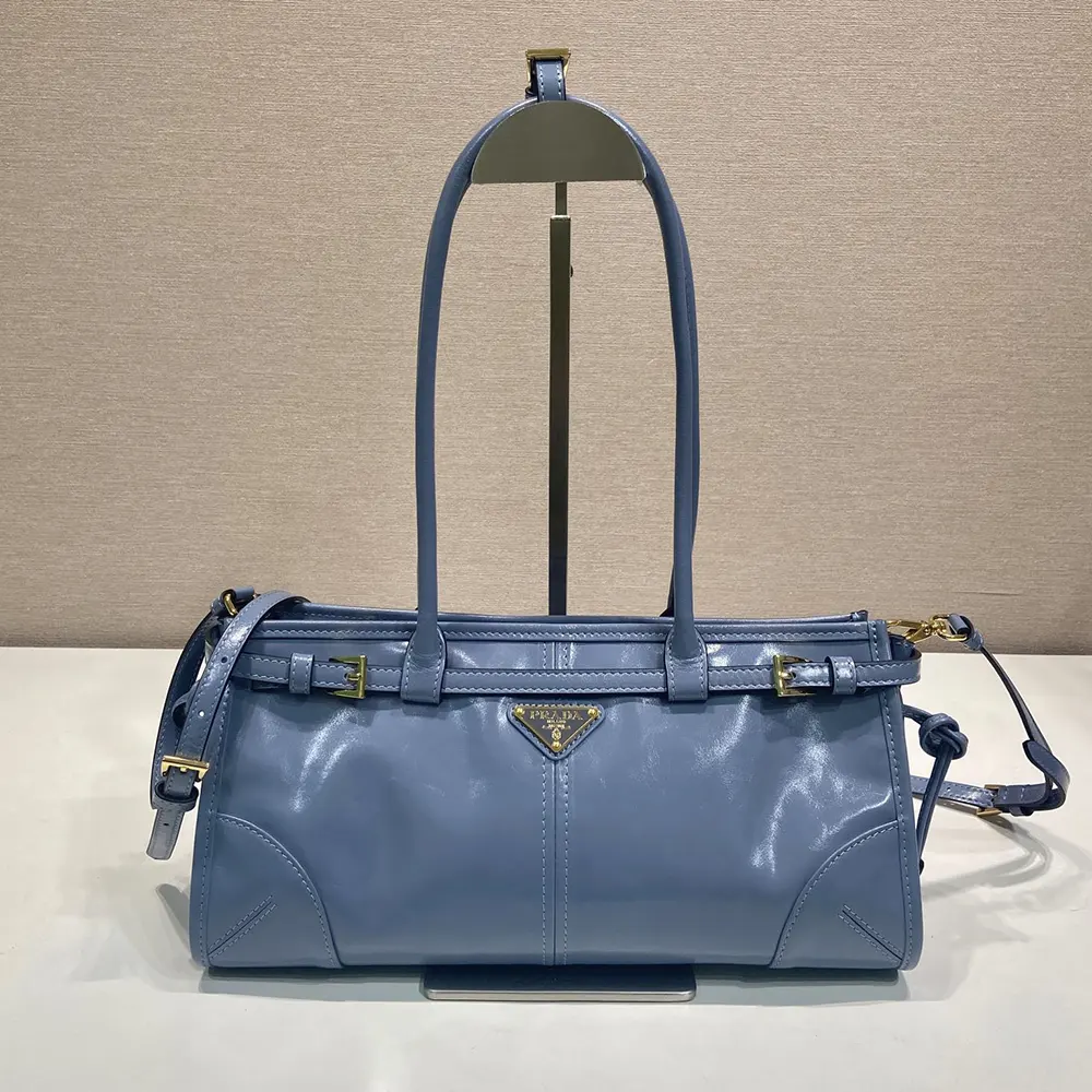 Close-up on silver Prada hardware on handbag strap