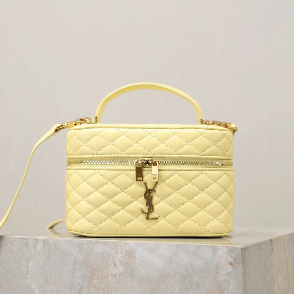 Close-up of gold YSL logo on yellow lambskin vanity bag