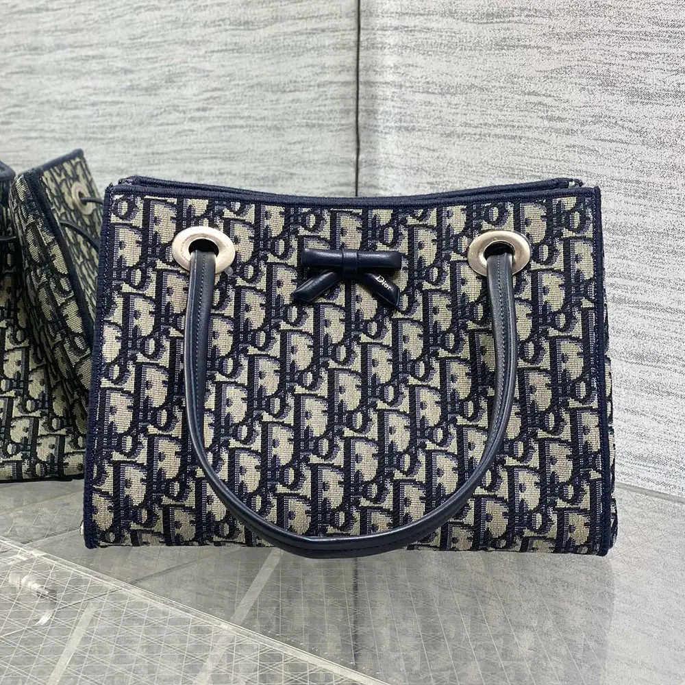 Close-up of blue jacquard fabric and silver hardware on Dior bag