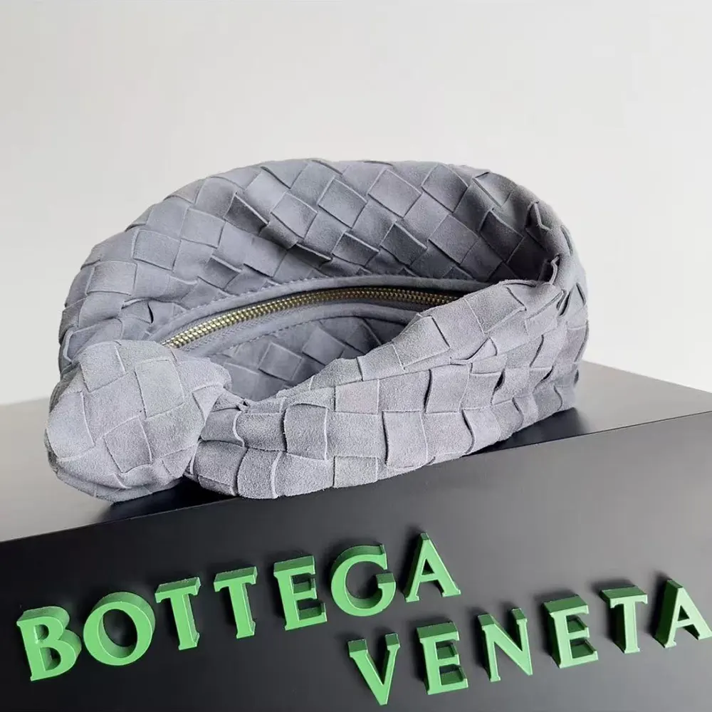 Side angle showing compact silhouette of Bottega Veneta Mini Jodie shoulder bag