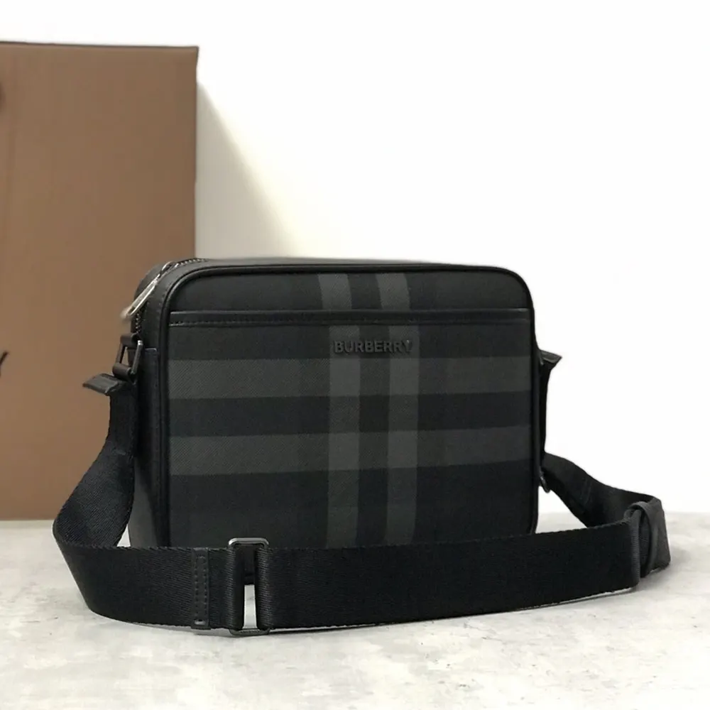 Side angle of Burberry Men Muswell Bag-Black highlighting compact silhouette