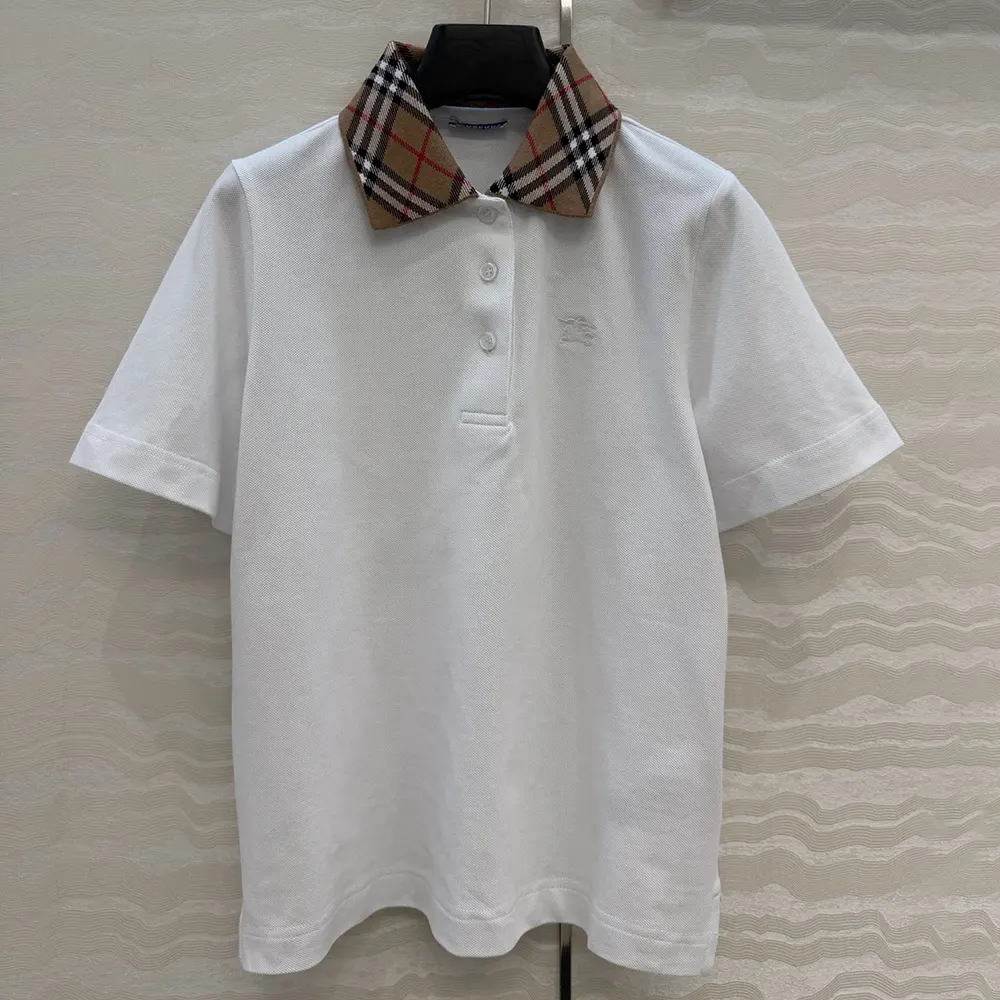 Close-up of Burberry check collar detail on white cotton polo shirt