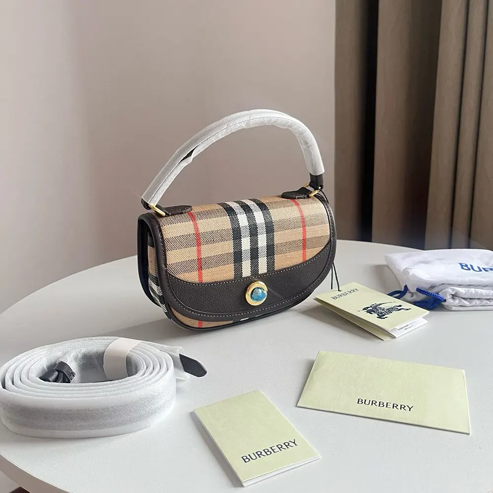 Interior shot showing signature check lining in Burberry Women Highlands Crossbody Bag