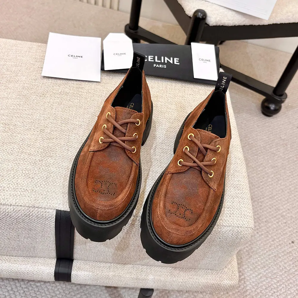 Close-up of gold Triomphe hardware on brown Celine Women Triomphe Derbies