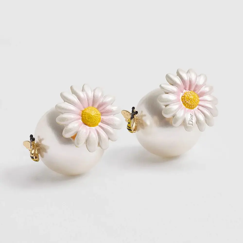 Front close-up of Dior Women Daisy Dior Tribales Earrings showing white resin pearls