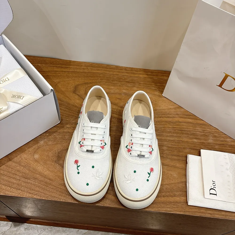 Close-up of multicolor doves and roses embroidery on Dior Saltwind Sneaker