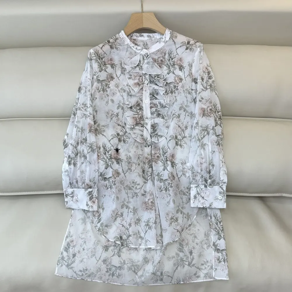Close-up on multicolor Rosier de Dior floral pattern on white blouse