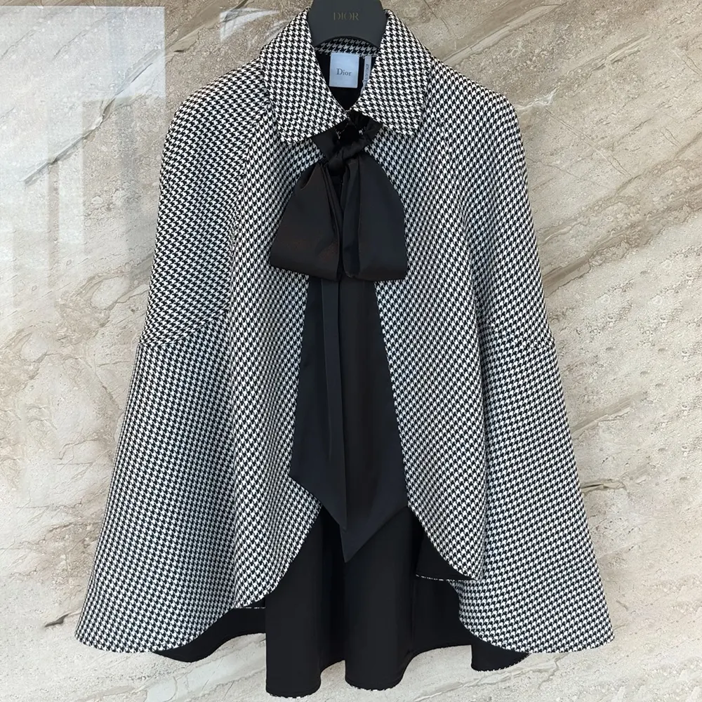 Close-up of tied neckline detail on Dior Women Cape in black and white houndstooth