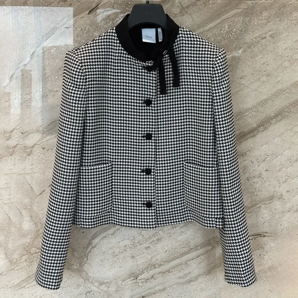 Close-up detail of Dior buttons on houndstooth cropped jacket
