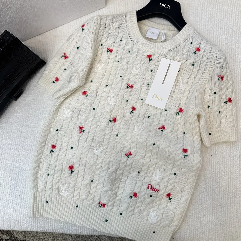 Close-up detail of Dioramour embroidery on white cashmere sweater