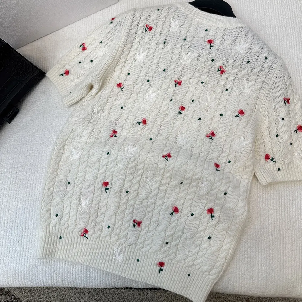 Side profile showing short sleeves and cable-knit texture