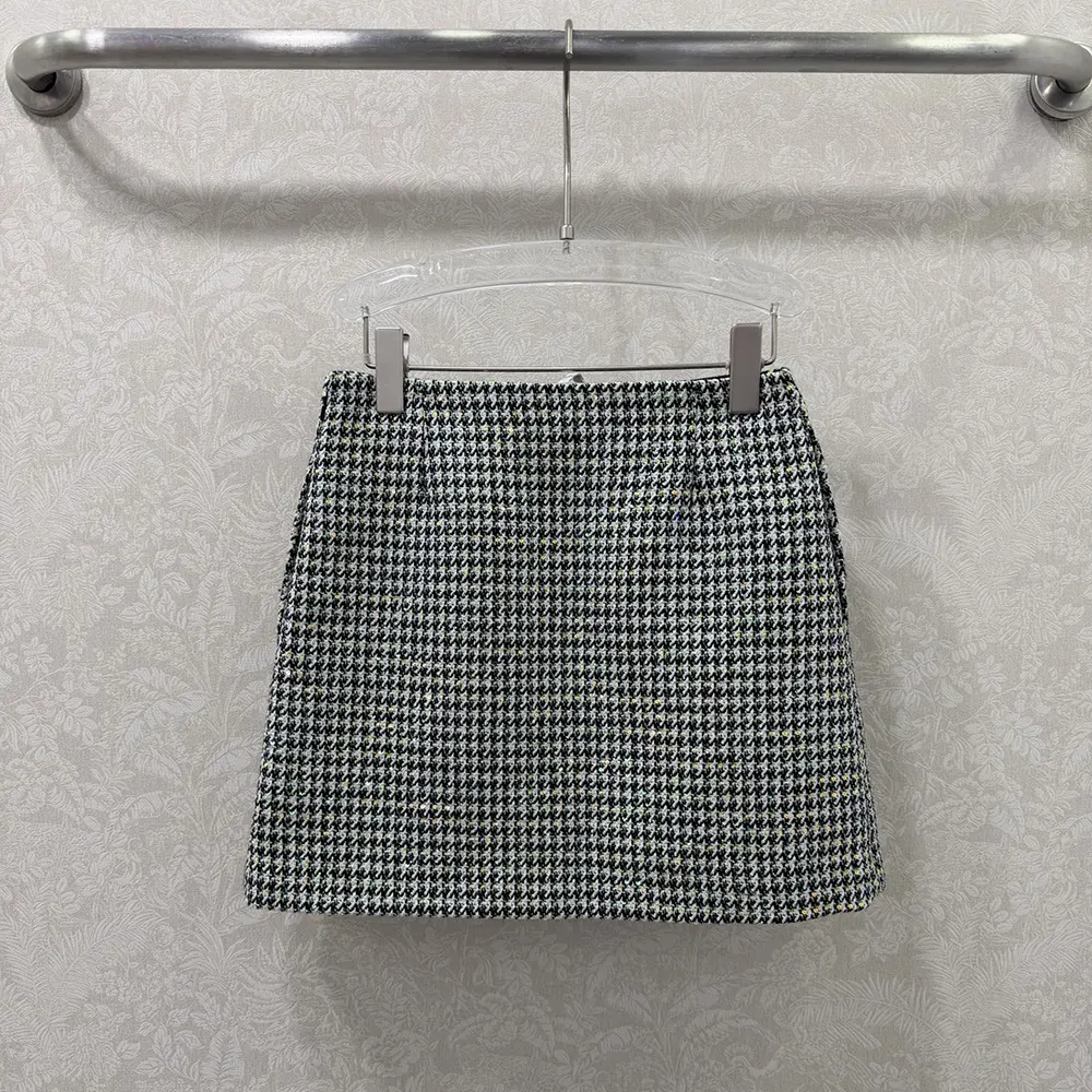 Side angle showing flared silhouette and concealed zip on Dior miniskirt
