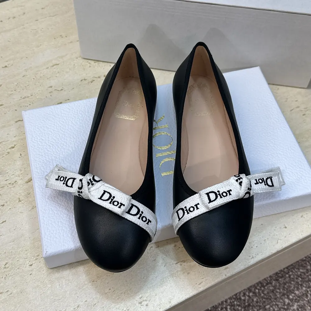 Overhead shot showing black lambskin texture on Dior ballet flat