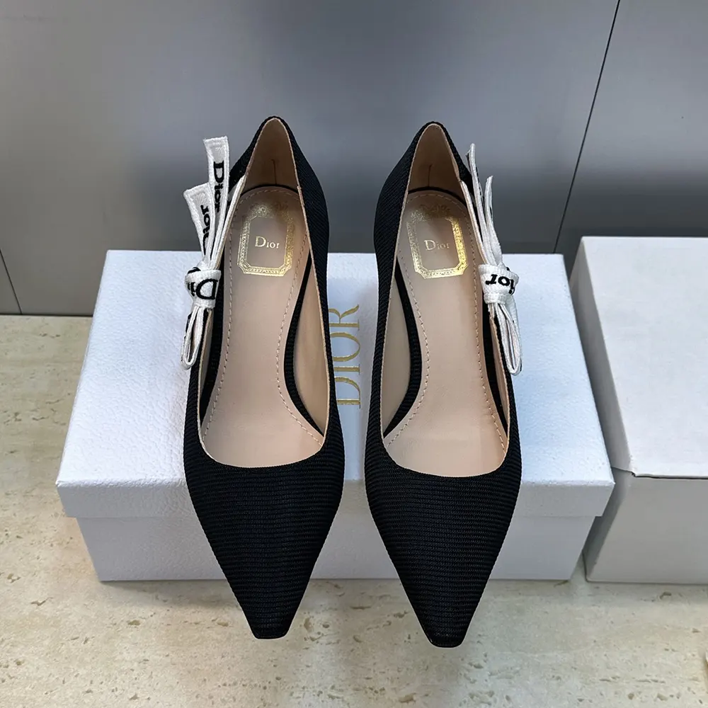 Close-up of gold J’Adior buckle on black technical fabric pump
