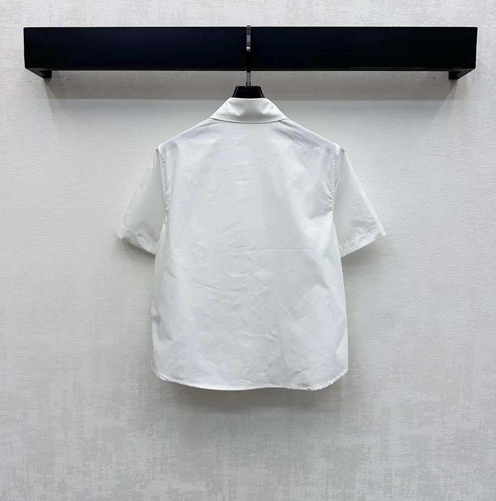 Side angle showing tailored fit of Dior Women Médaillon Embroidered blouse