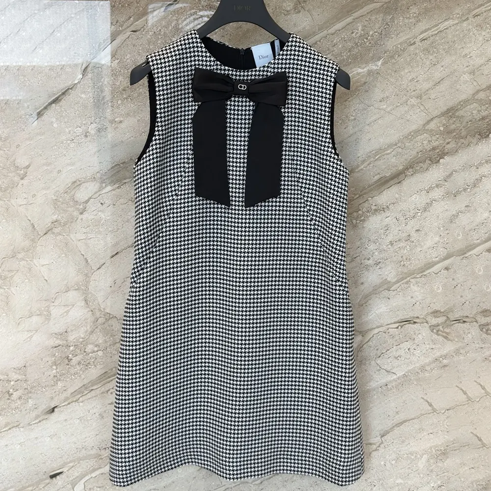 Close-up of signature Dior buttons on houndstooth wool blend dress