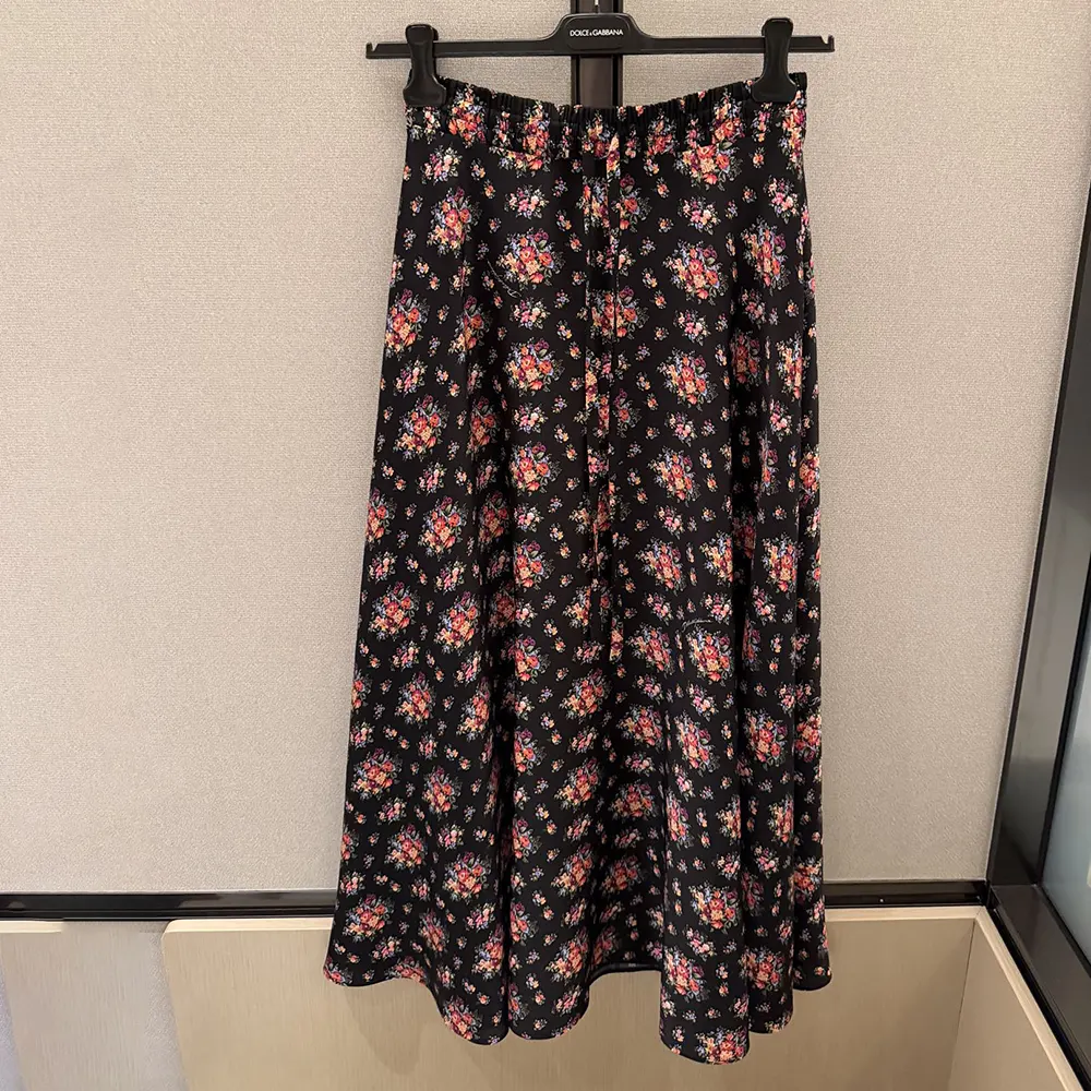 Close-up of floral print and signature button on Dolce Gabbana D&G skirt