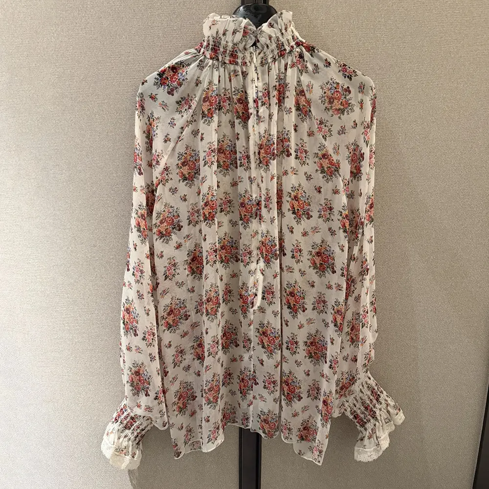 Close-up of pink floral print on Dolce Gabbana D&G chiffon top