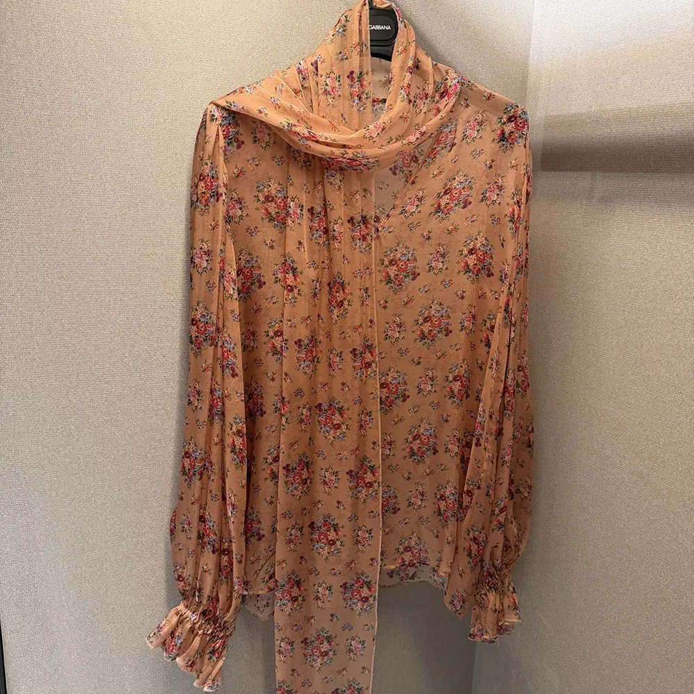 Side angle showing relaxed fit of Dolce Gabbana D&G chiffon top