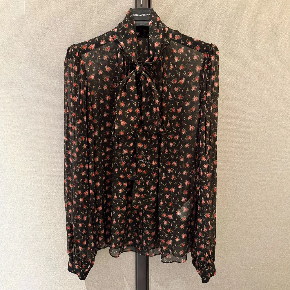 Close-up of rose print and logo hardware on Dolce Gabbana D&G chiffon top