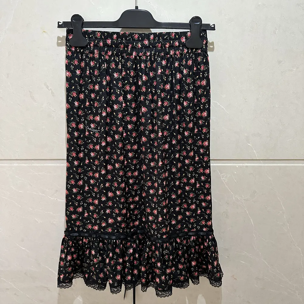 Close-up of rose print and flounce hem on Dolce Gabbana D&G skirt