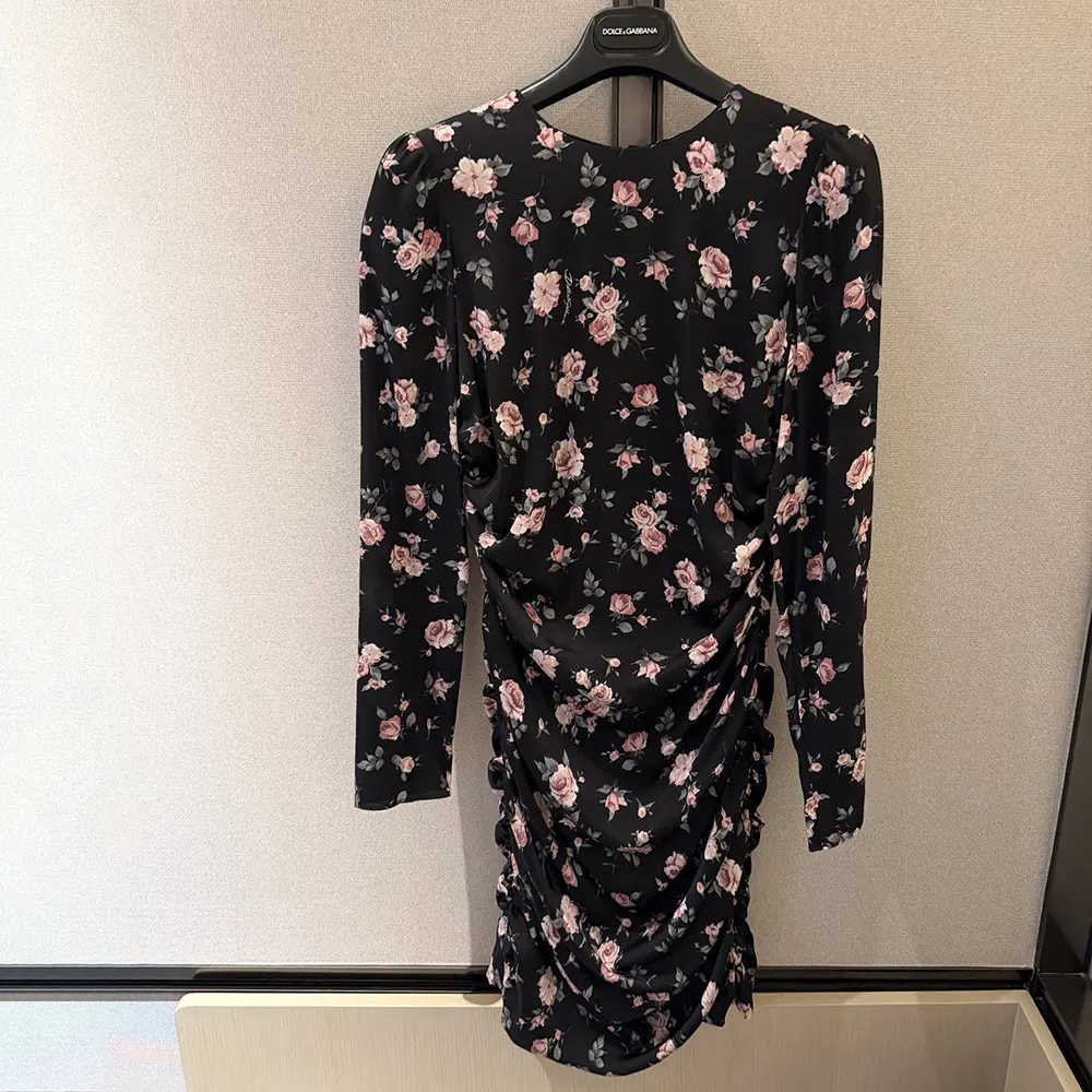 Close-up of vintage rose print and draped detail on Dolce Gabbana D&G dress