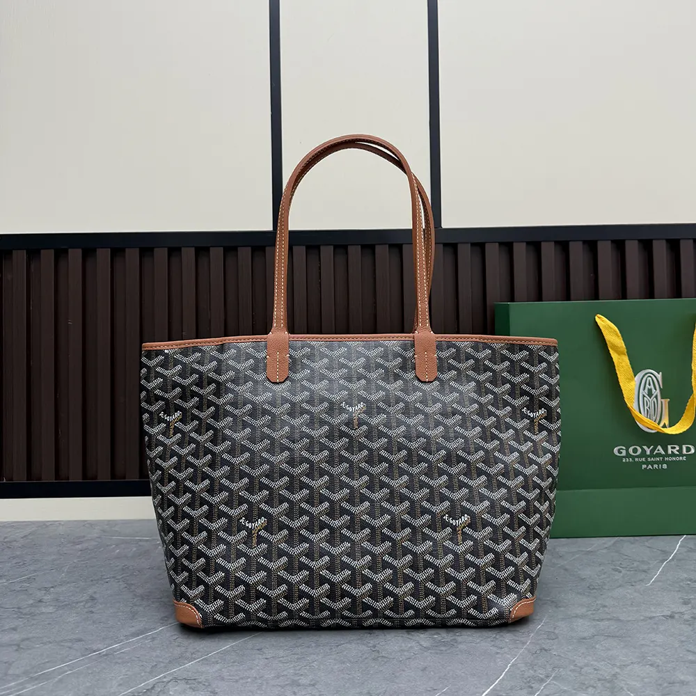 Close-up on tan leather trim and brass hardware of Goyard Artois PM Bag