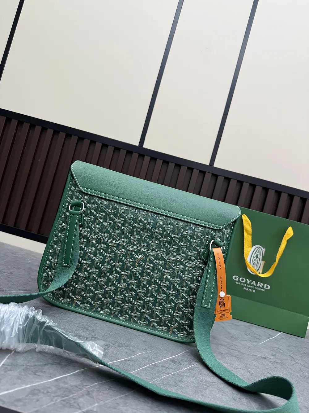 Side profile of green Goyard Unisex Coursier Messenger Bag with strap