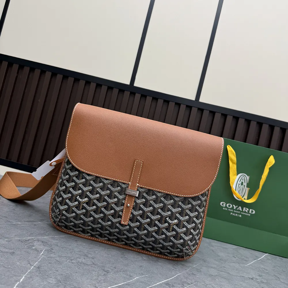 Close-up of tan leather trim and brass hardware on Goyard messenger bag
