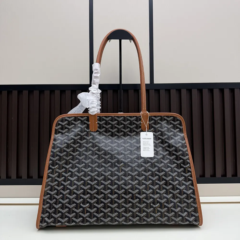 Side angle showing the structured silhouette of Goyard Unisex Hardy Pm Bag-Tan