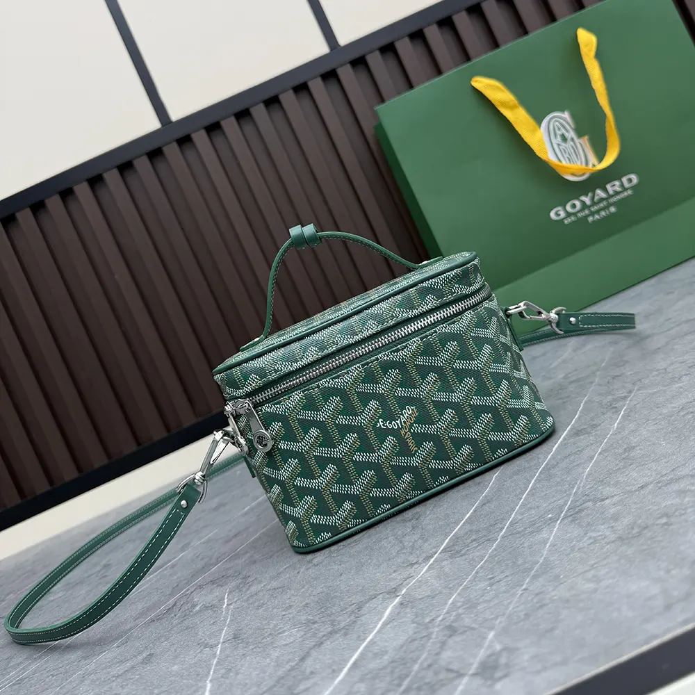 Side angle showing leather trim and adjustable strap on Goyard Unisex Muse Mini Vanity-Green