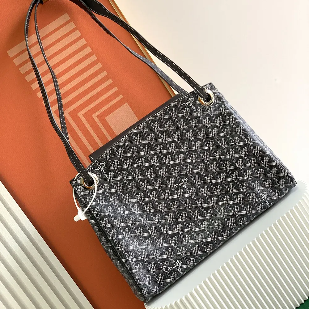 Side angle showing soft structure and adjustable strap on Goyard bag