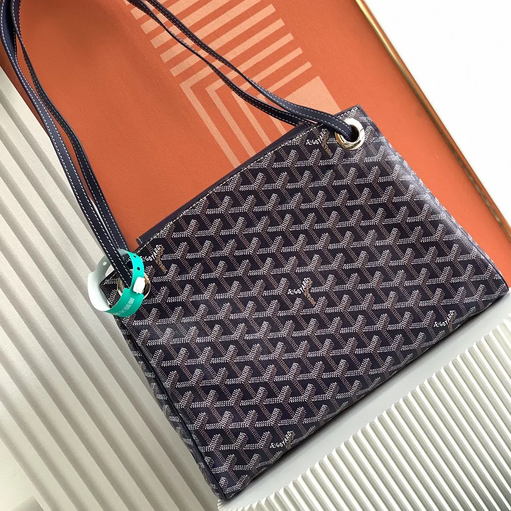 Side profile of Goyard Unisex Rouette Souple Bag-Navy with leather trim details
