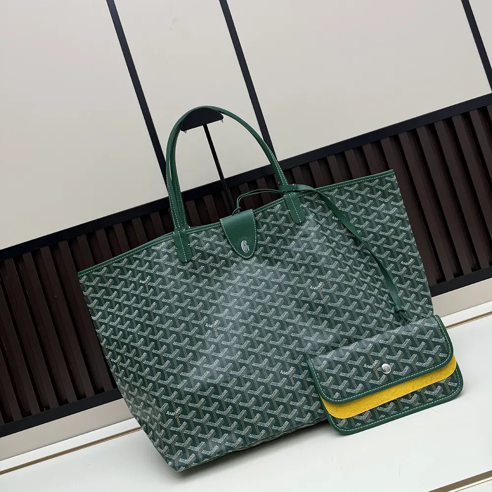 Close-up of leather trim and brass hardware on Goyard Saint Louis Gm Bag-Green