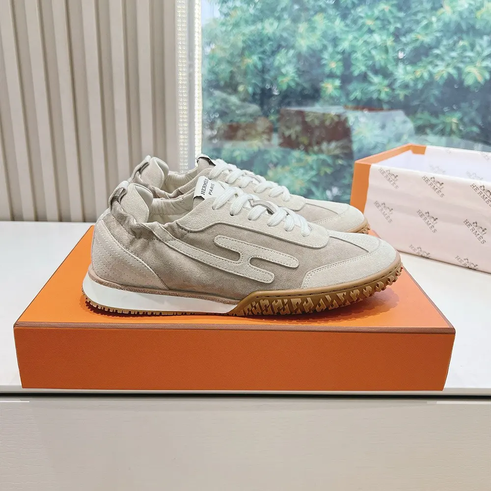 Close-up on beige suede goatskin and Hermes logo hardware detail