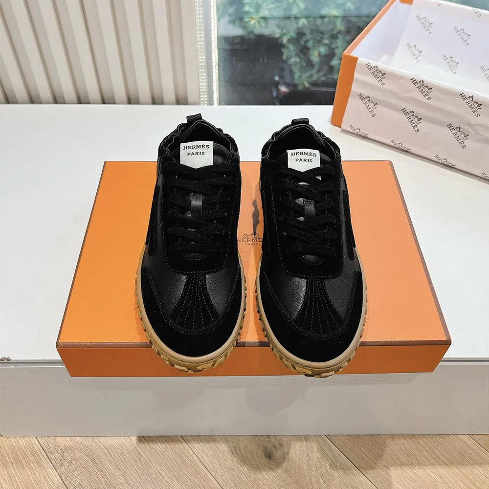 Close-up of embossed Hermes hardware on black Jet Sneaker