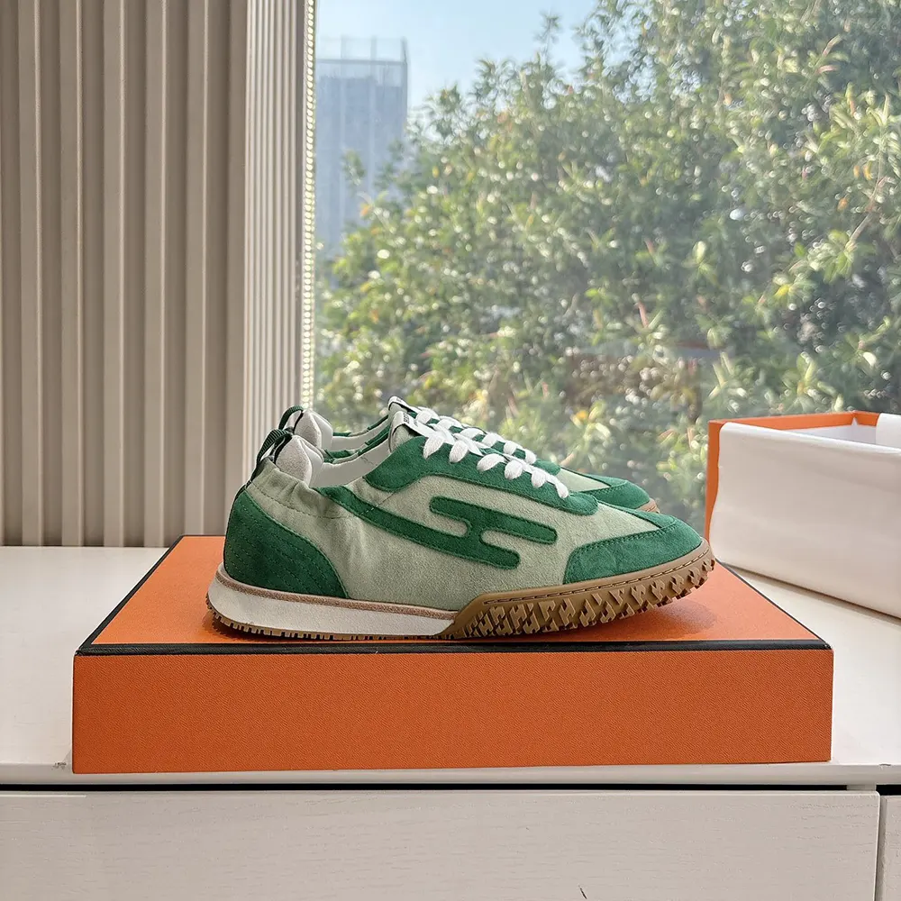 Close-up of embossed Hermes logo on green Jet Sneaker hardware