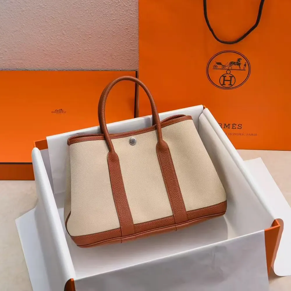 Close-up on gold hardware and perforated H detail of Hermes Women Garden Party 36 Bag-Brown