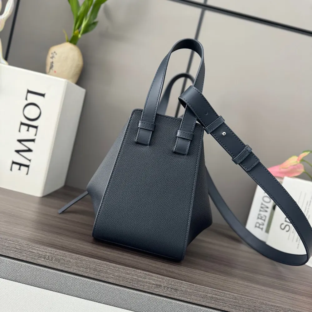 Side view showing silver hardware and adjustable strap on Loewe Compact Hammock Bag