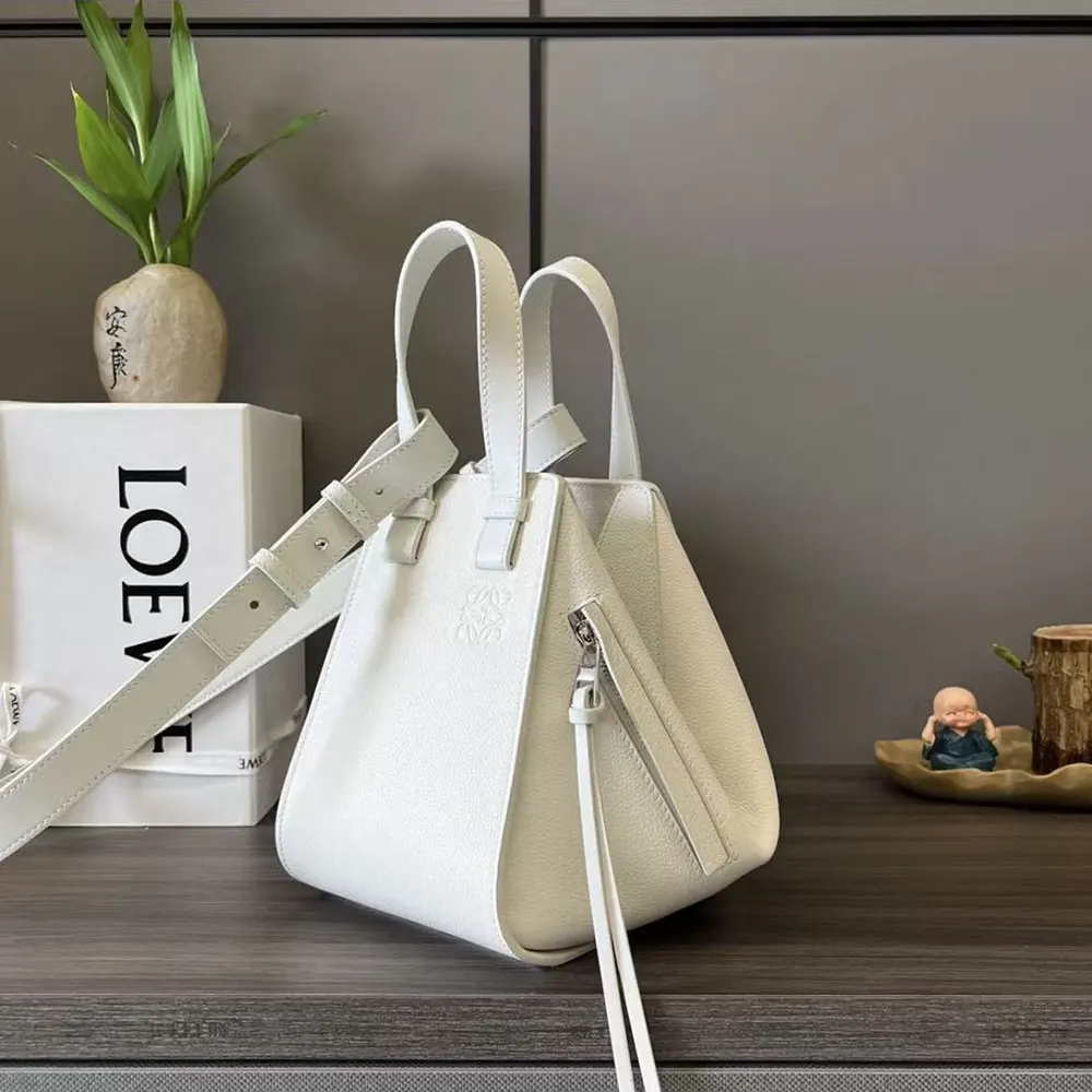Side view highlighting magnetic closure detail on Loewe Unisex Compact Hammock Bag White