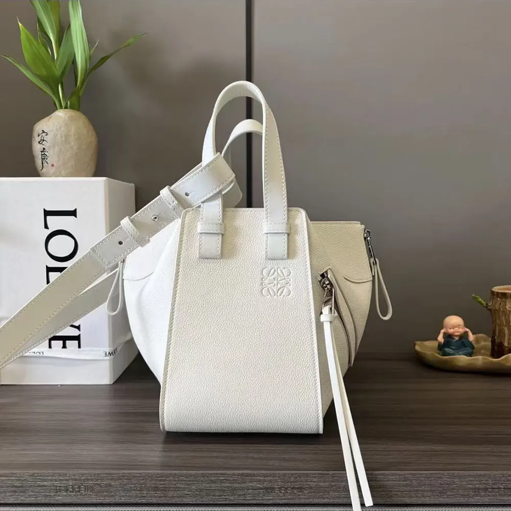 Close-up of soft grained calfskin texture and silver hardware on Loewe Compact Hammock Bag