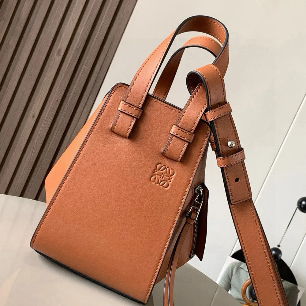 Close-up of tan calfskin leather and Loewe hardware on Compact Hammock Bag