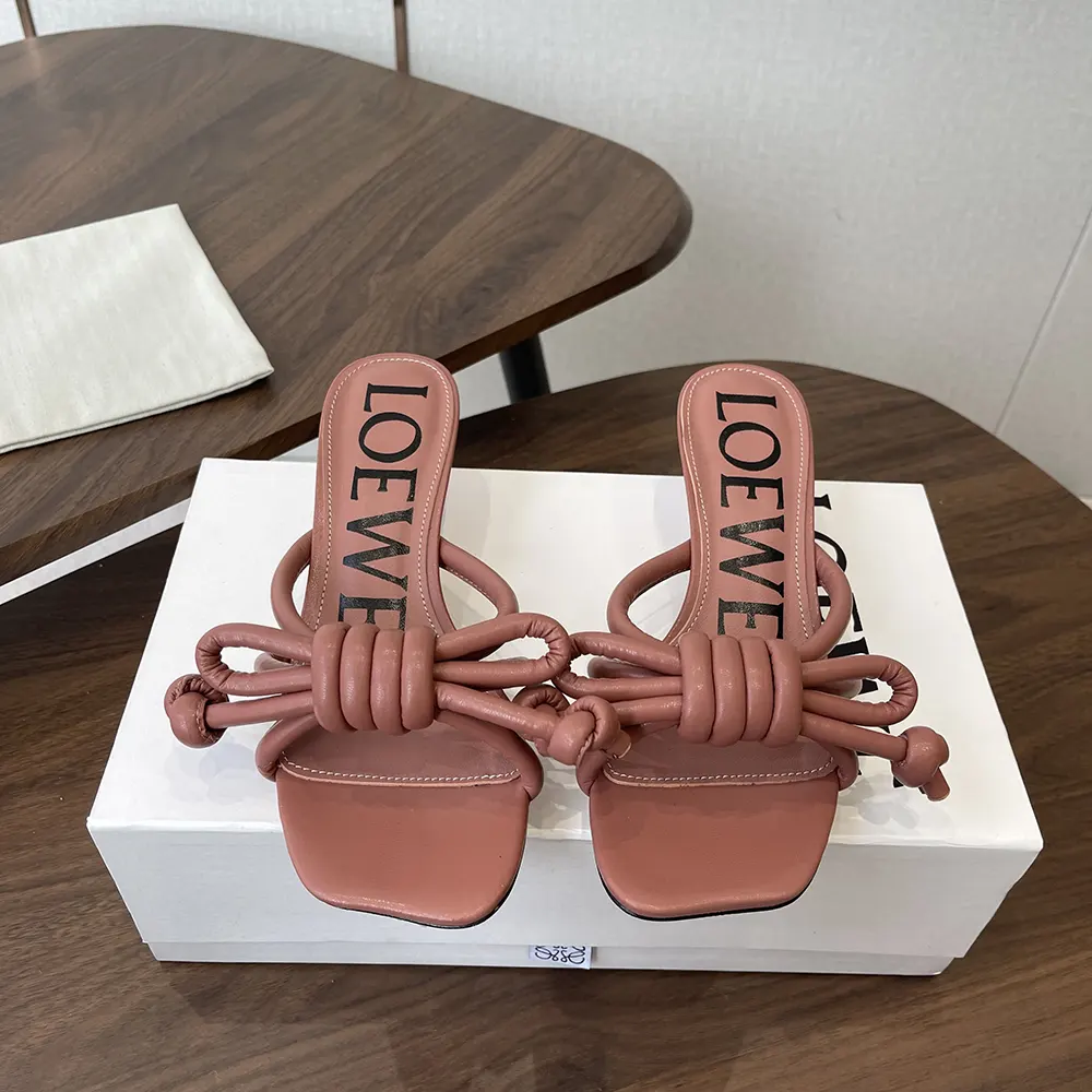 Close-up of the signature Flamenco knot on pink lambskin sandal