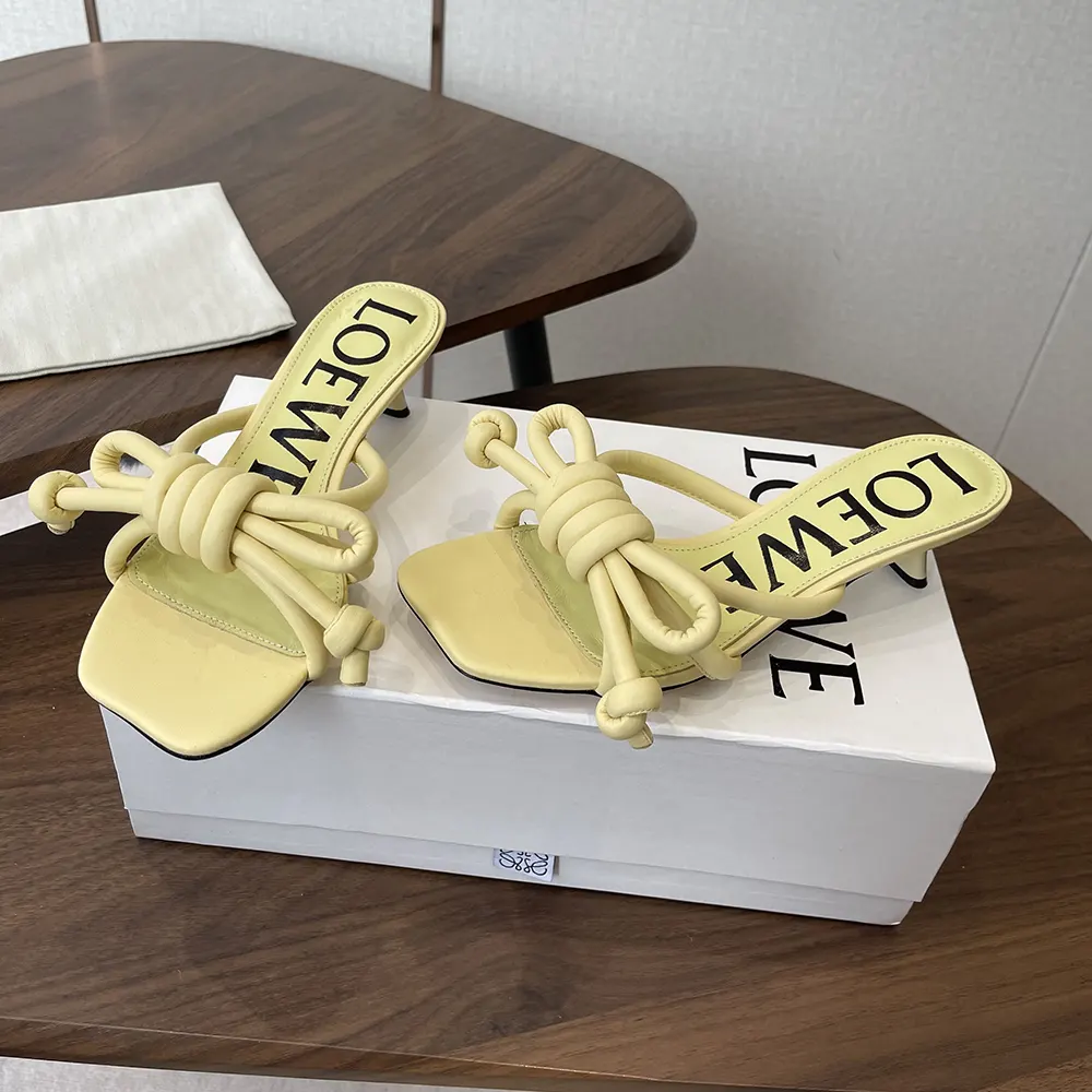Close-up of yellow lambskin and Flamenco knot detail on sandal