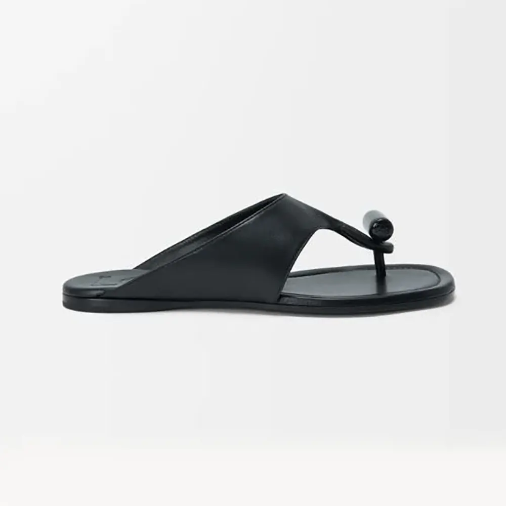 Side profile of Loewe Women Toggle Flat Sandal in shiny black calfskin