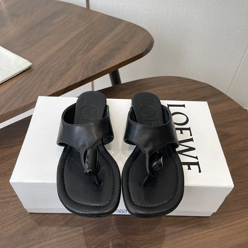 Close-up of toggle hardware detail on Loewe Women Toggle Flat Sandal