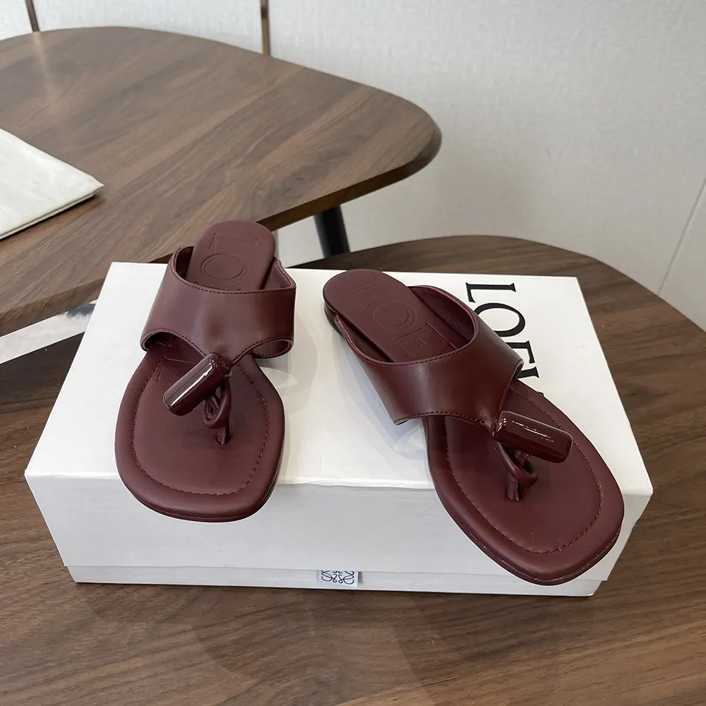 Close-up of polished toggle detail on Loewe Women Toggle Flat Sandal